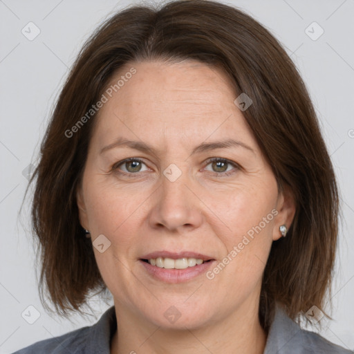 Joyful white adult female with medium  brown hair and grey eyes