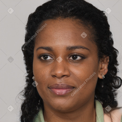 Joyful black young-adult female with long  brown hair and brown eyes