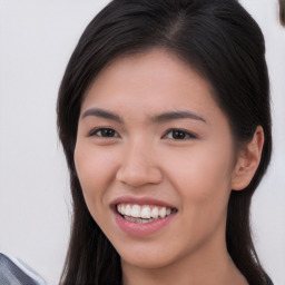 Joyful asian young-adult female with long  brown hair and brown eyes