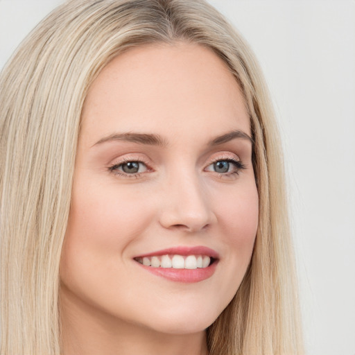 Joyful white young-adult female with long  brown hair and blue eyes