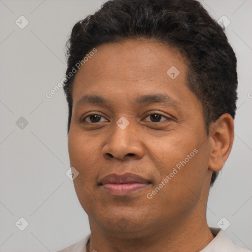 Joyful black young-adult male with short  brown hair and brown eyes