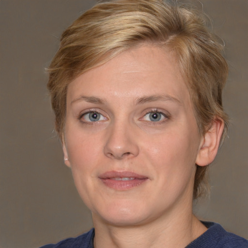 Joyful white adult female with medium  brown hair and blue eyes