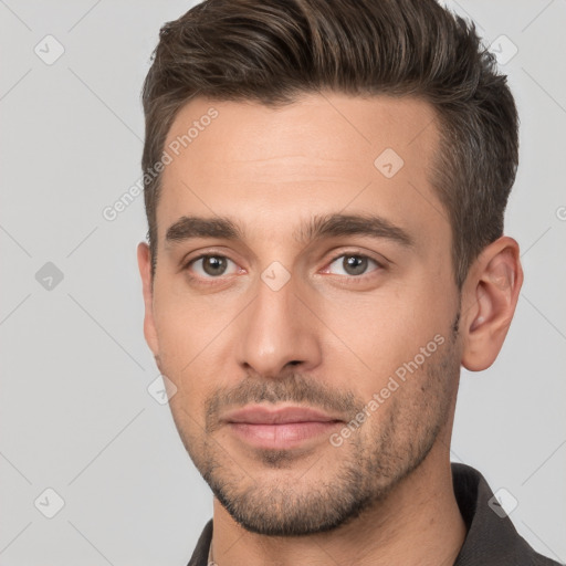 Joyful white young-adult male with short  brown hair and brown eyes