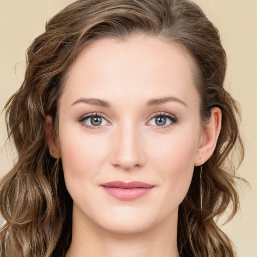 Joyful white young-adult female with long  brown hair and green eyes