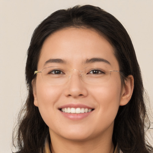 Joyful white young-adult female with long  brown hair and brown eyes