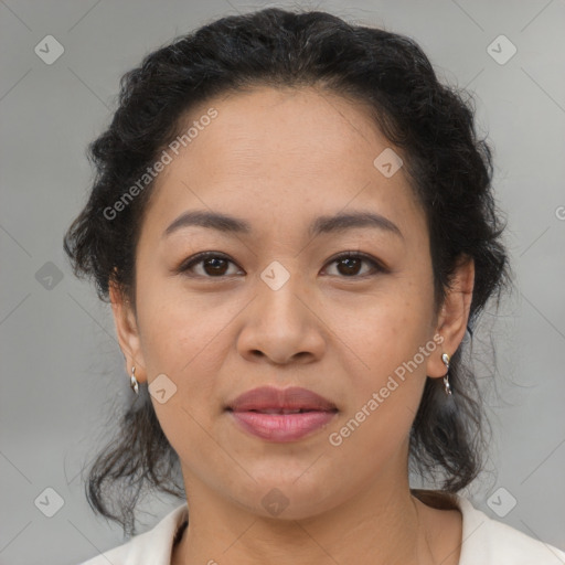 Joyful latino adult female with medium  brown hair and brown eyes