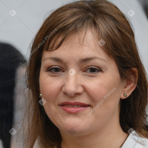 Joyful white adult female with medium  brown hair and brown eyes