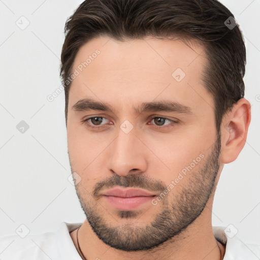 Joyful white young-adult male with short  brown hair and brown eyes