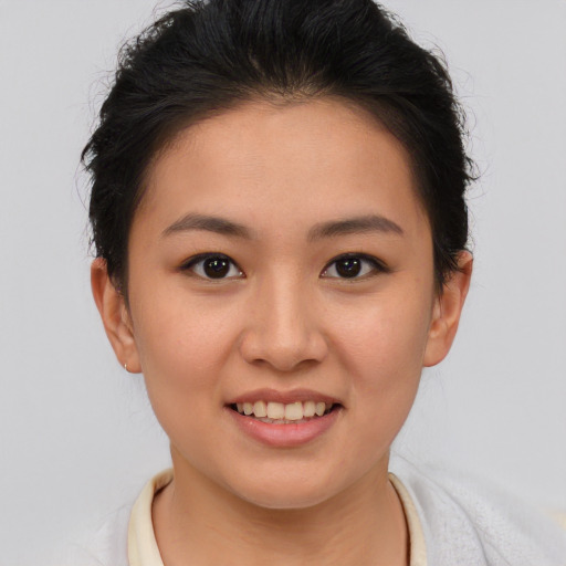Joyful asian young-adult female with short  brown hair and brown eyes