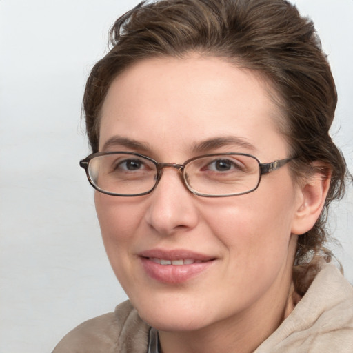 Joyful white adult female with medium  brown hair and blue eyes