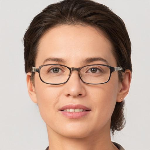 Joyful white young-adult female with short  brown hair and grey eyes