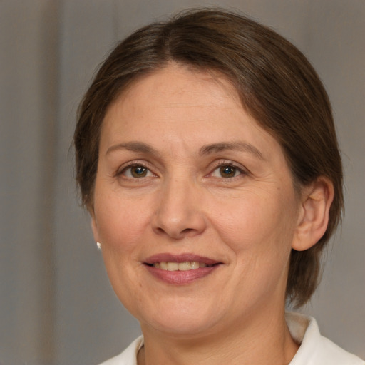 Joyful white adult female with medium  brown hair and brown eyes