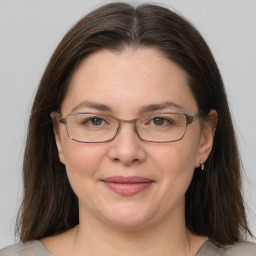 Joyful white adult female with medium  brown hair and grey eyes