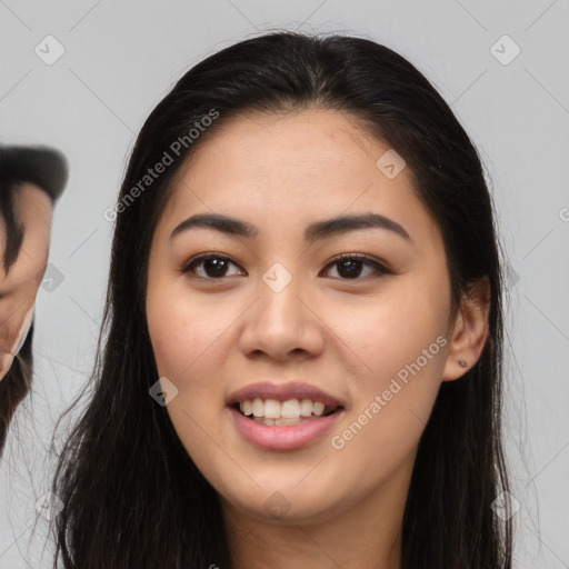 Joyful asian young-adult female with long  brown hair and brown eyes