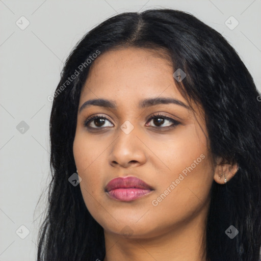 Joyful latino young-adult female with long  black hair and brown eyes