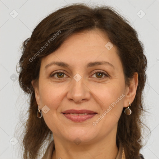 Joyful white adult female with long  brown hair and brown eyes