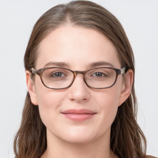 Joyful white young-adult female with long  brown hair and grey eyes