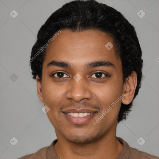 Joyful black young-adult male with short  black hair and brown eyes