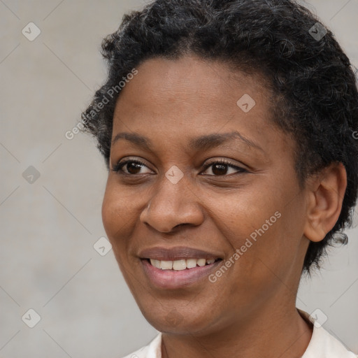 Joyful black young-adult female with short  brown hair and brown eyes