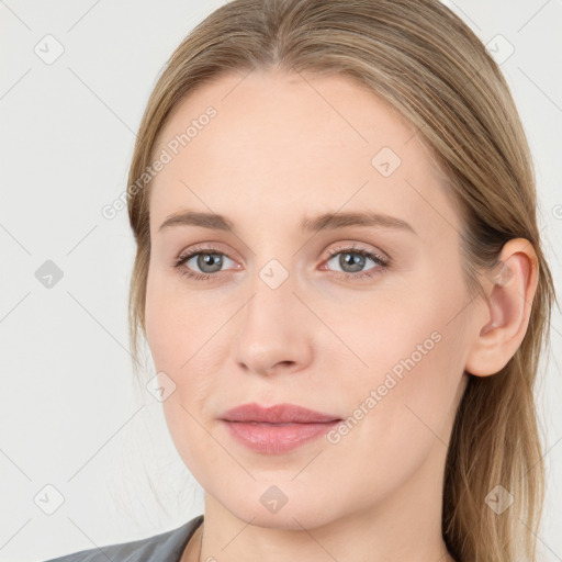 Joyful white young-adult female with long  brown hair and blue eyes