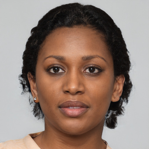 Neutral black young-adult female with medium  brown hair and brown eyes
