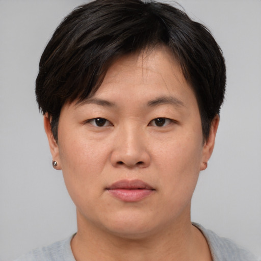 Neutral asian adult female with short  brown hair and brown eyes