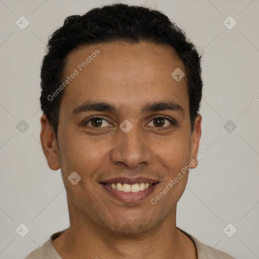 Joyful latino young-adult male with short  black hair and brown eyes