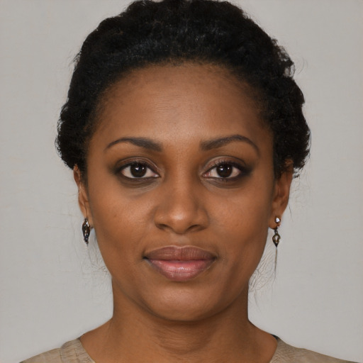 Joyful black young-adult female with short  brown hair and brown eyes