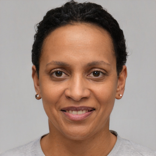 Joyful latino young-adult female with short  black hair and brown eyes