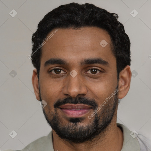Joyful black young-adult male with short  black hair and brown eyes
