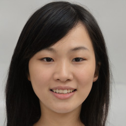 Joyful asian young-adult female with long  brown hair and brown eyes