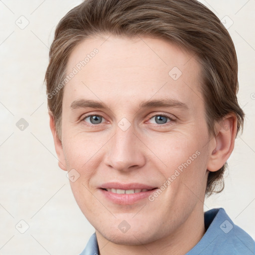 Joyful white young-adult male with short  brown hair and grey eyes