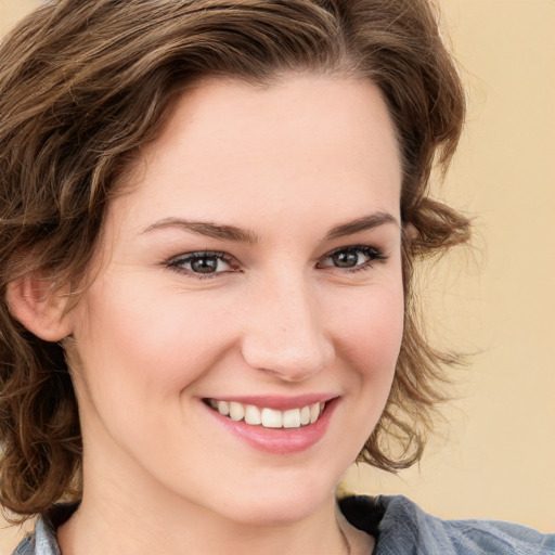 Joyful white young-adult female with medium  brown hair and blue eyes