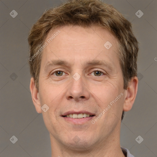 Joyful white adult male with short  brown hair and grey eyes