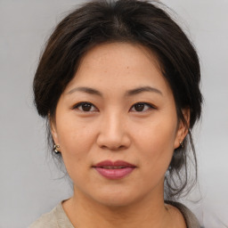 Joyful asian young-adult female with medium  brown hair and brown eyes