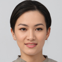 Joyful asian young-adult female with short  black hair and brown eyes