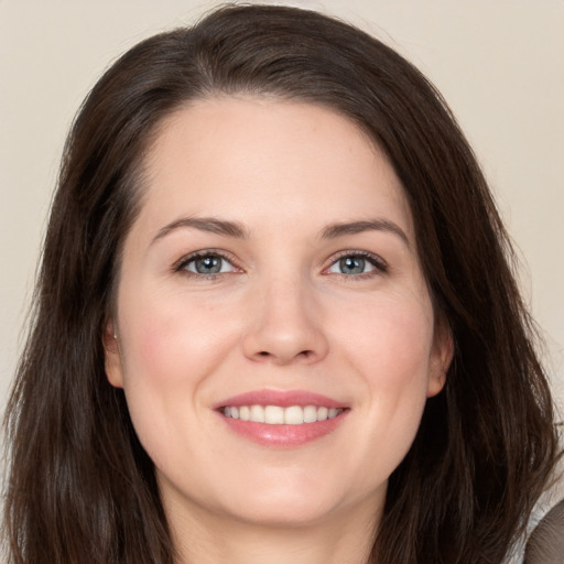 Joyful white young-adult female with long  brown hair and brown eyes