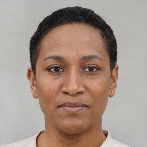 Joyful latino young-adult female with short  black hair and brown eyes
