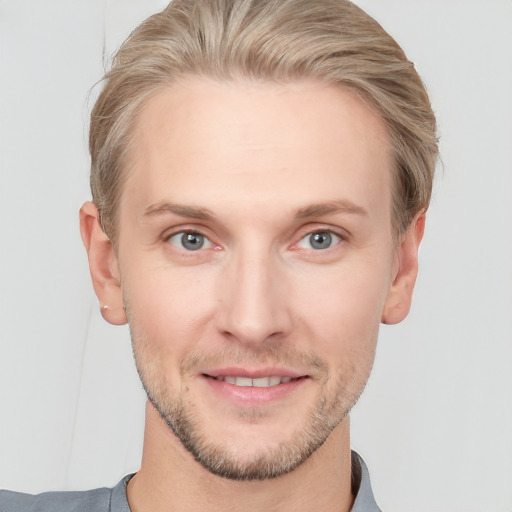 Joyful white young-adult male with short  brown hair and grey eyes