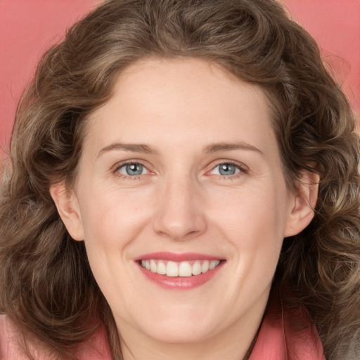 Joyful white adult female with medium  brown hair and green eyes