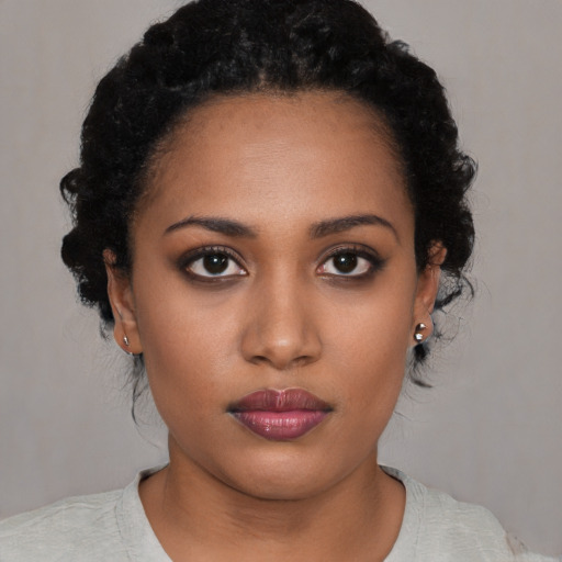Neutral black young-adult female with medium  black hair and brown eyes