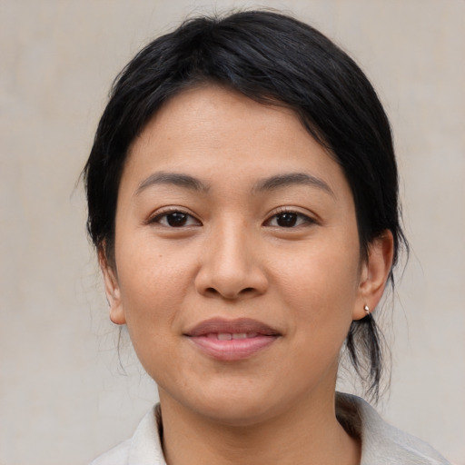 Joyful asian young-adult female with medium  black hair and brown eyes