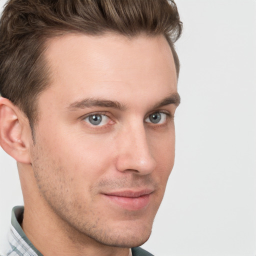 Joyful white young-adult male with short  brown hair and grey eyes