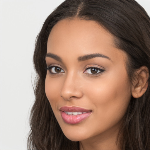 Joyful latino young-adult female with long  brown hair and brown eyes