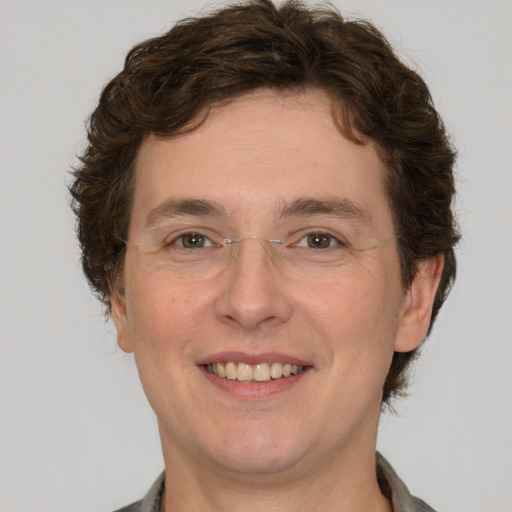 Joyful white young-adult male with short  brown hair and green eyes