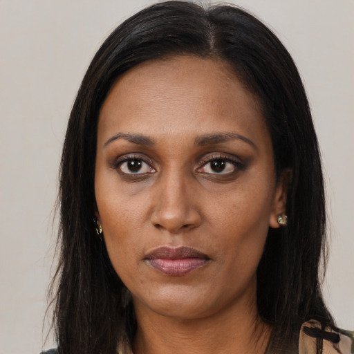 Neutral black adult female with long  brown hair and brown eyes
