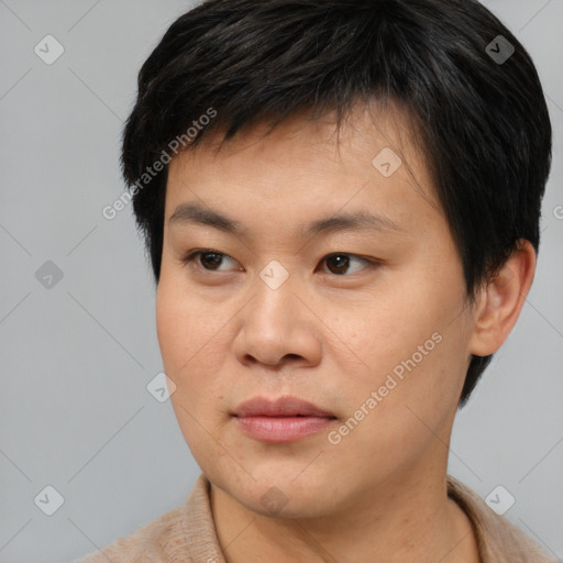 Joyful asian young-adult male with short  brown hair and brown eyes