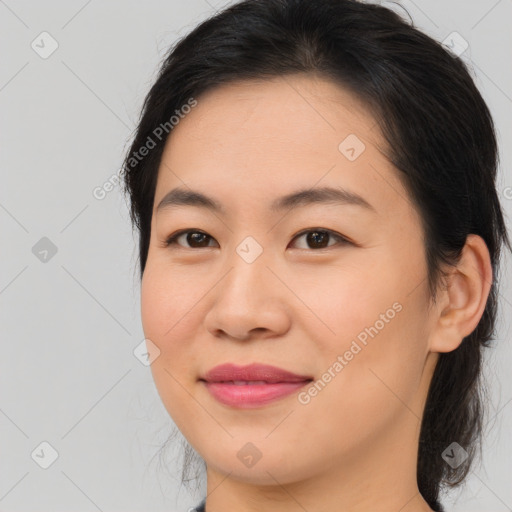 Joyful asian young-adult female with medium  brown hair and brown eyes