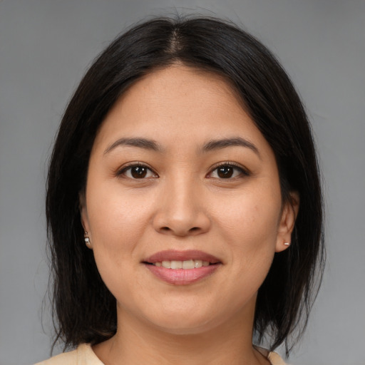 Joyful asian young-adult female with medium  brown hair and brown eyes