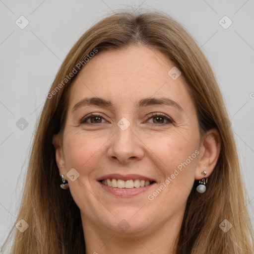 Joyful white adult female with long  brown hair and grey eyes